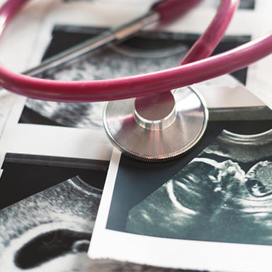 stethoscope and ultrasound photo with baby fetus