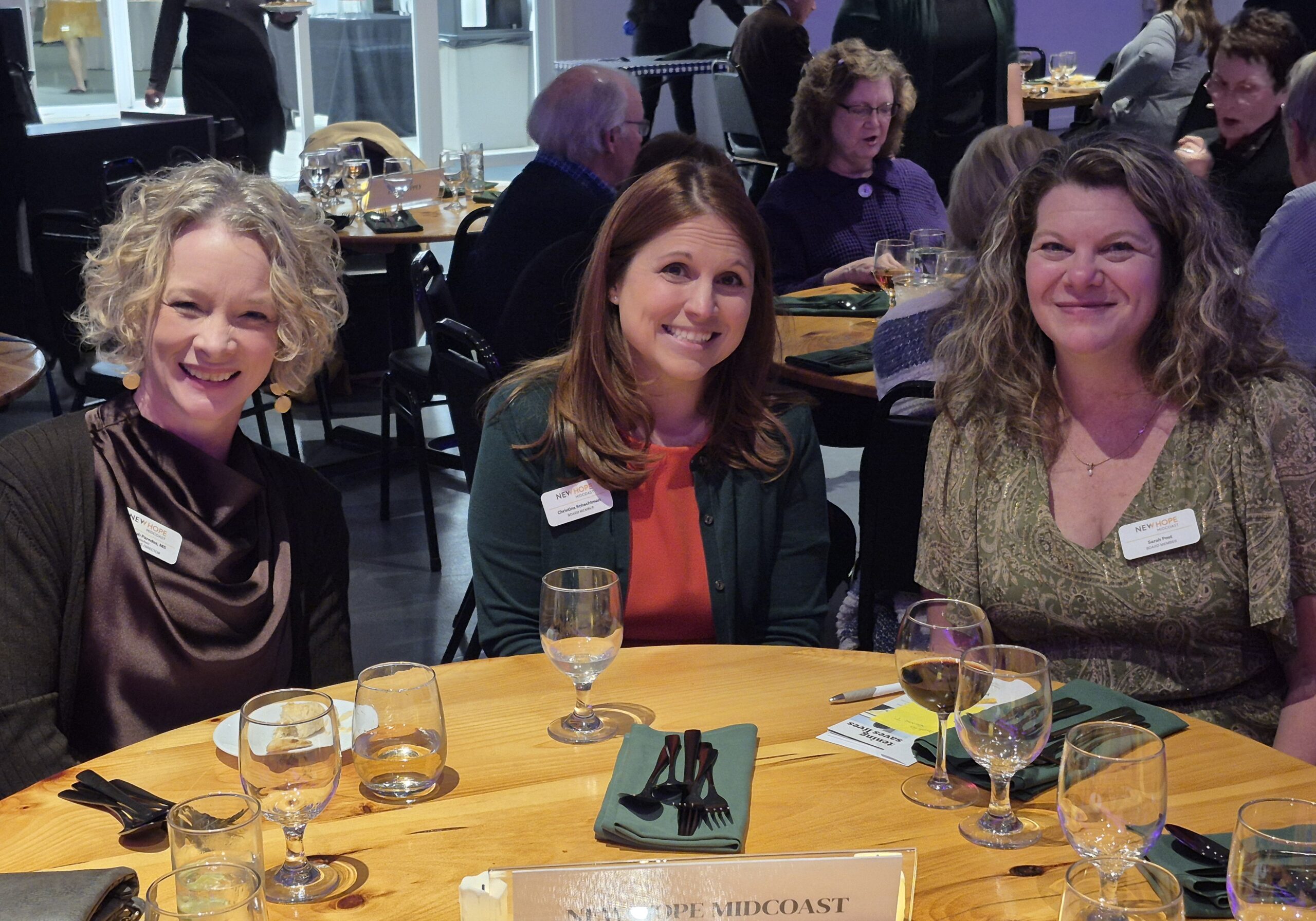 From left: New Hope Midcoast Executive Director Rebekah Paredes gathers with New Hope Midcoast Board Secretary, Christina Schechtman, and Board President, Sarah Post at the 2025 Belfast Area Chamber of Commerce Gala.