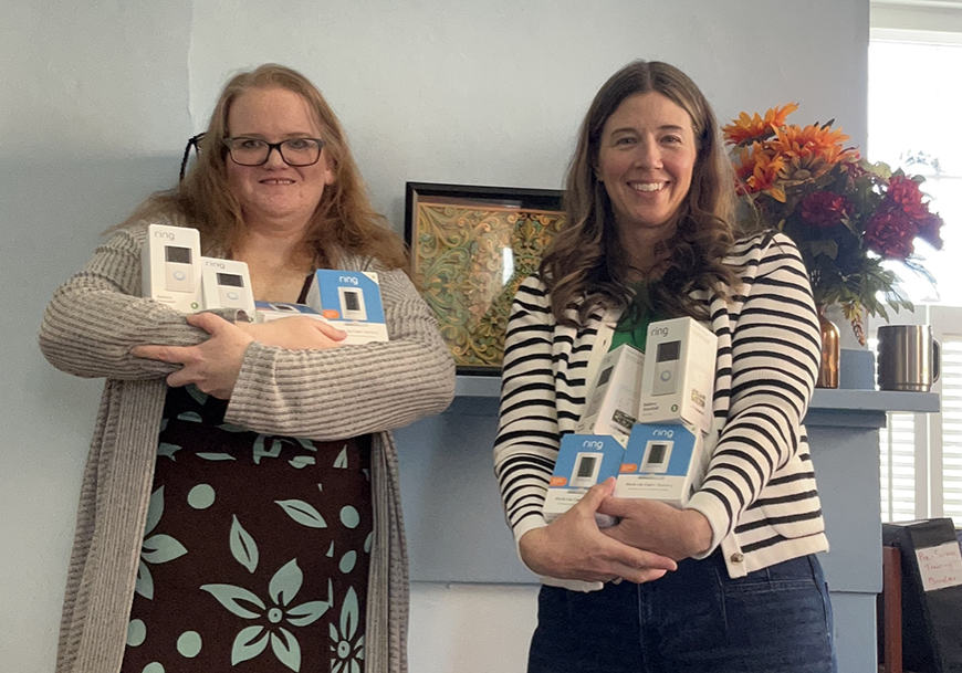 Staff members (L-R) Missy and Susanna show off our new supply of security cameras